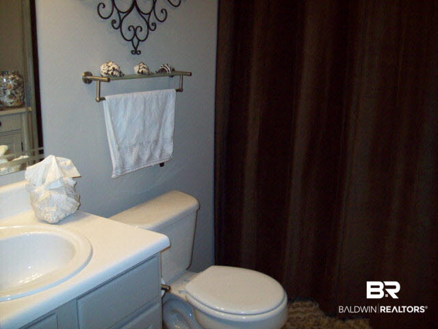 1517 Regency Road, Unit 123 Gulf Shores, AL 36542 - Photo 31 of 31 1/2 BATH DOWN STAIRS WITH WASHER & DRYER BEHIND DRAPE