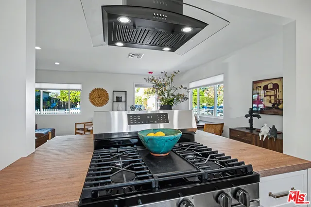 a kitchen with a stove and a wooden floors