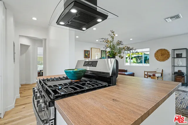 a kitchen with stove and refrigerator
