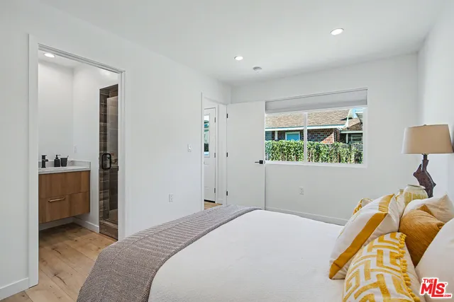 a bedroom with a bed and a view of kitchen