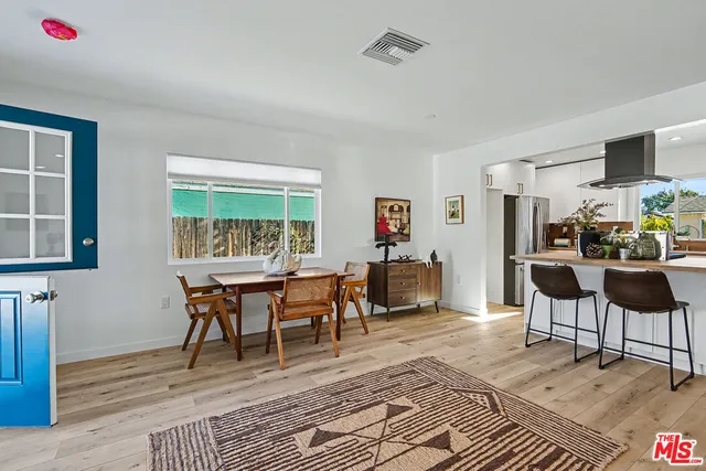 a dining room with furniture and wooden floor