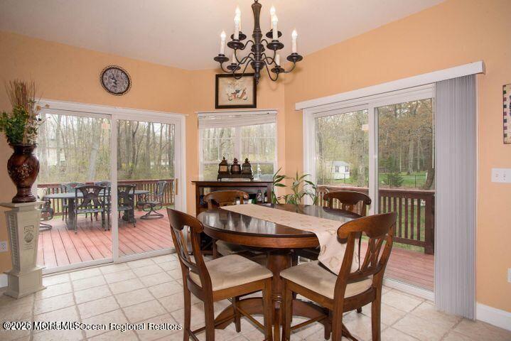 467 Leesville Road Jackson, NJ 08527 - Photo 10 of 19 a view of a dining room and livingroom with furniture wooden floor and a chandelier