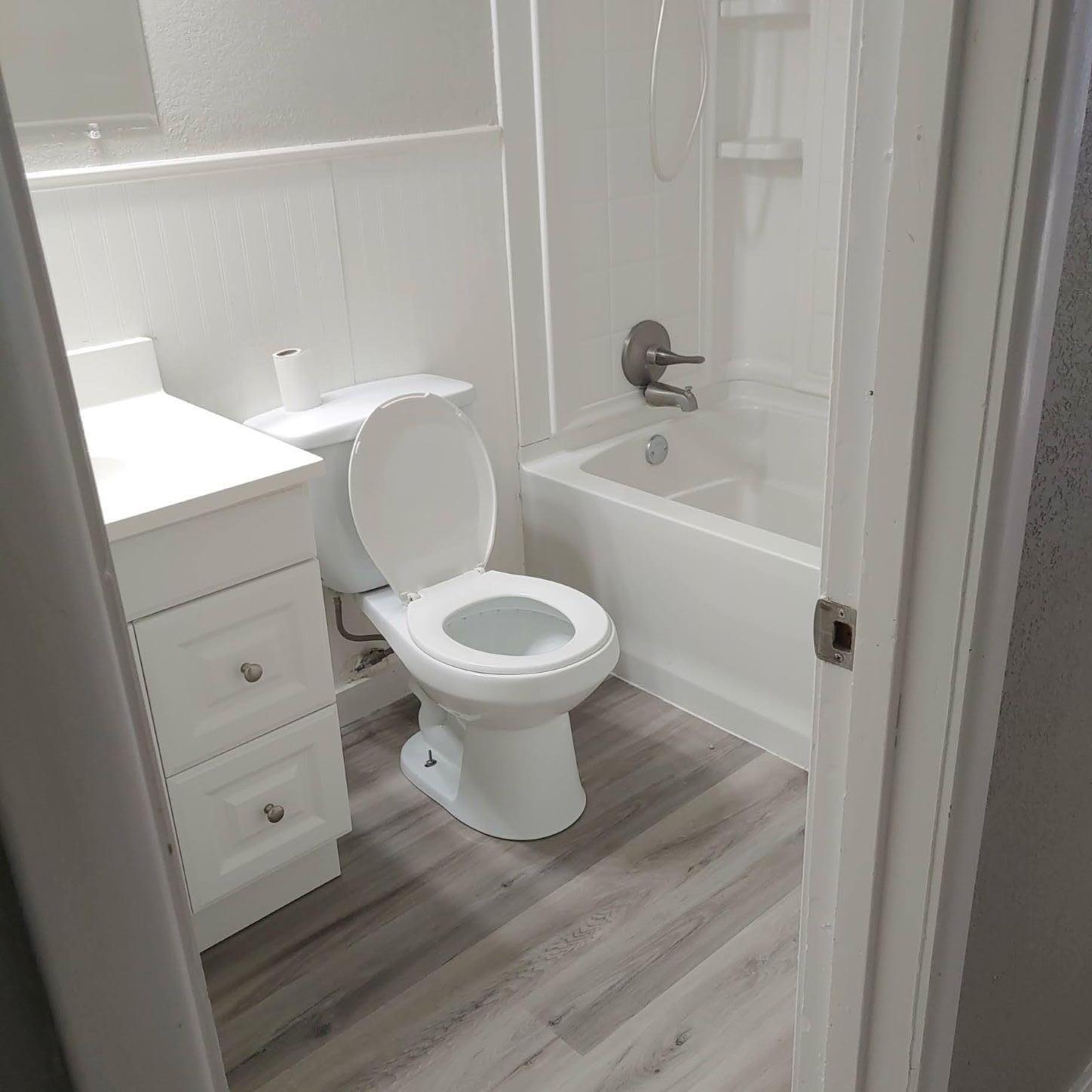 4304 South Hayden Street Amarillo, TX 79110 - Photo 17 of 22 a bathroom with a toilet sink and mirror