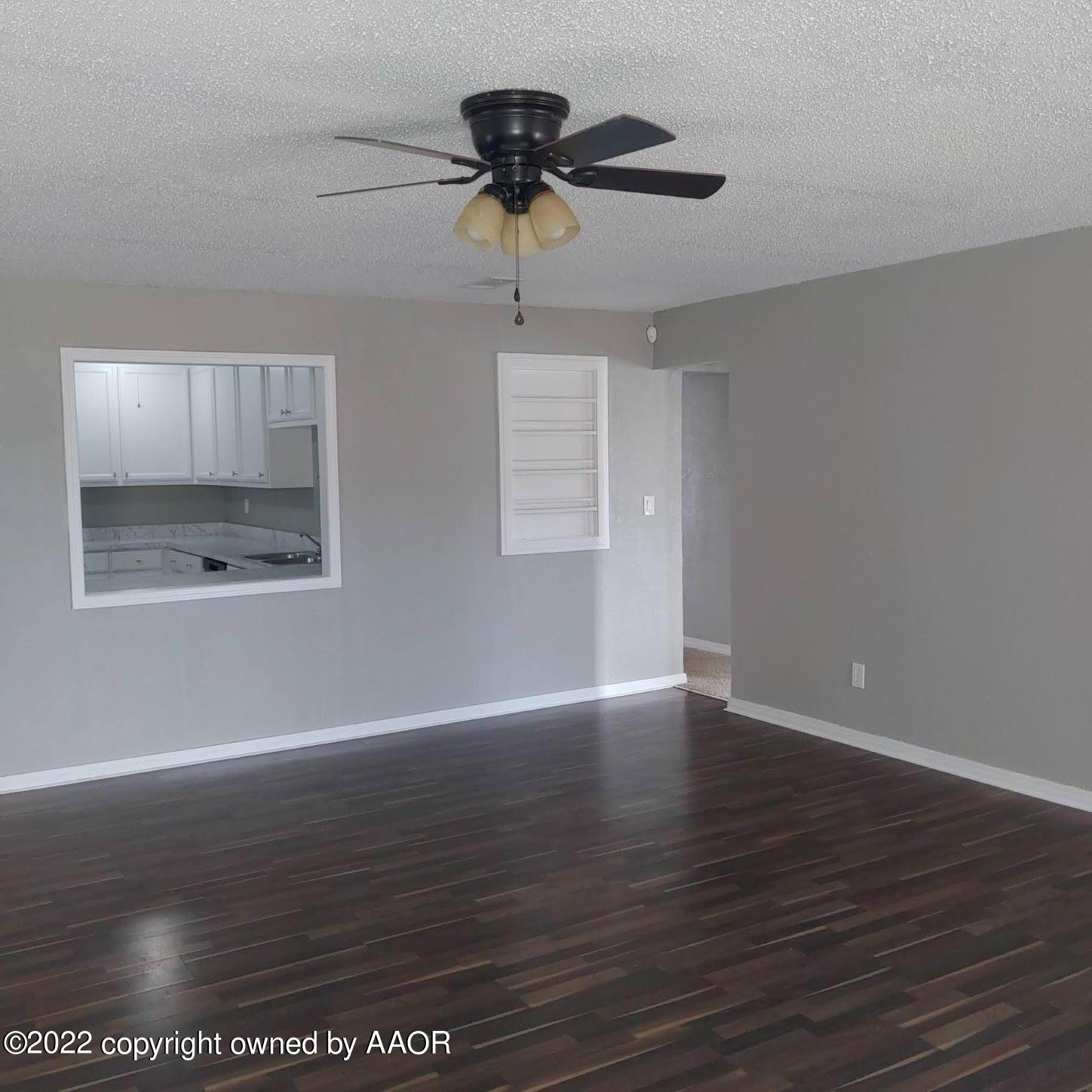 4304 South Hayden Street Amarillo, TX 79110 - Photo 3 of 22 a view of an empty room with wooden floor and a window