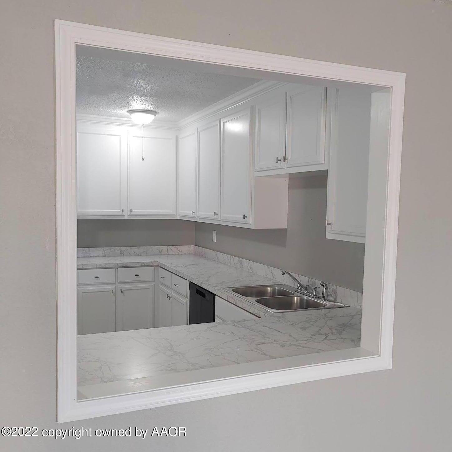 4304 South Hayden Street Amarillo, TX 79110 - Photo 4 of 22 a kitchen with white cabinets
