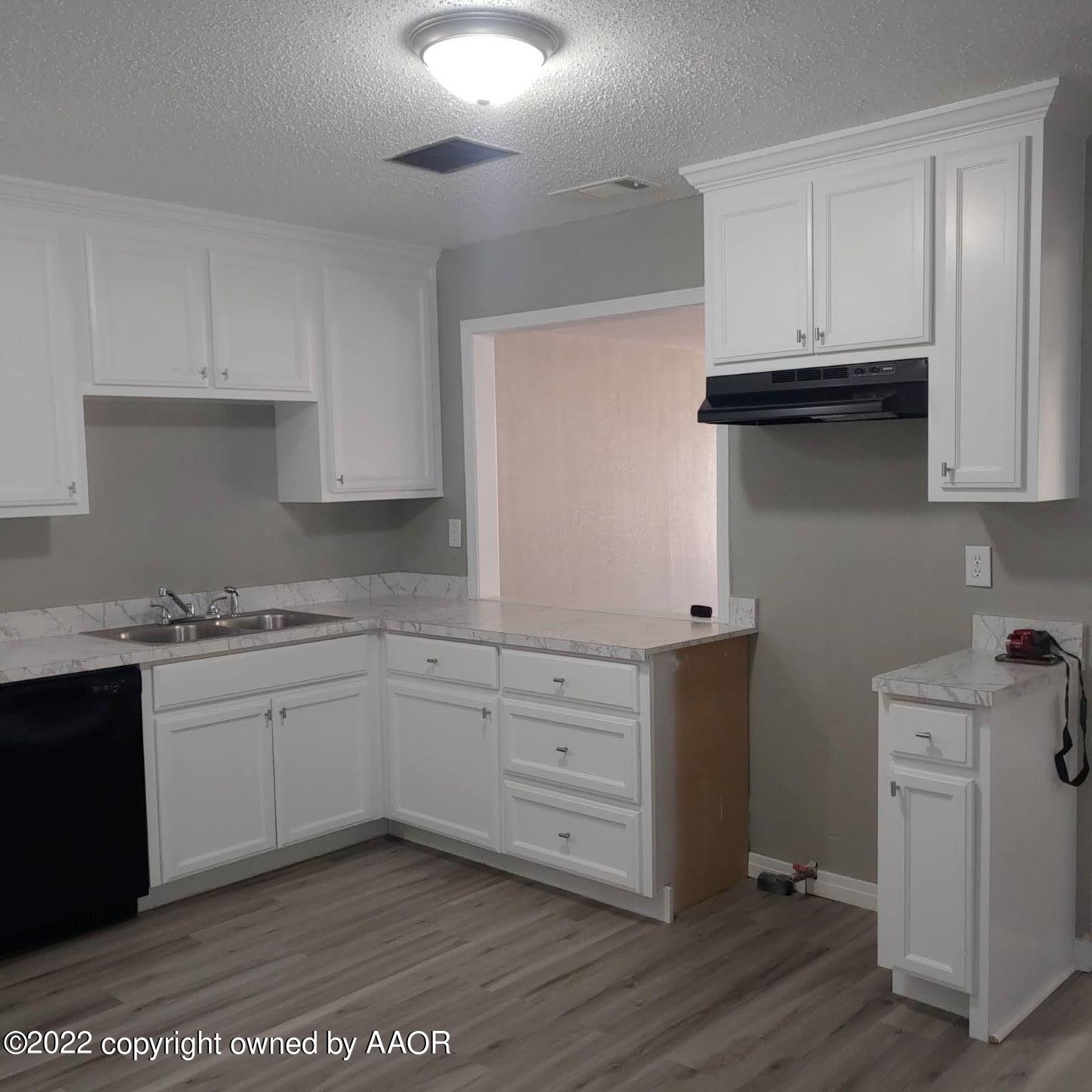 4304 South Hayden Street Amarillo, TX 79110 - Photo 5 of 22 a kitchen with granite countertop white cabinets and white appliances