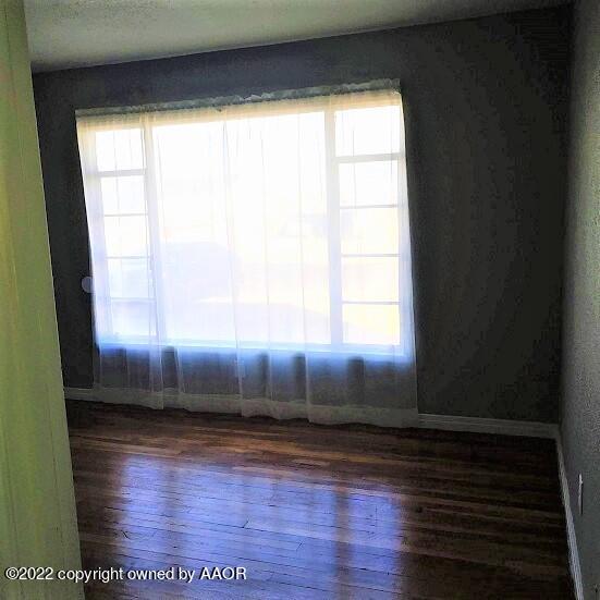 4304 South Hayden Street Amarillo, TX 79110 - Photo 9 of 22 a view of empty room with wooden floor and fan