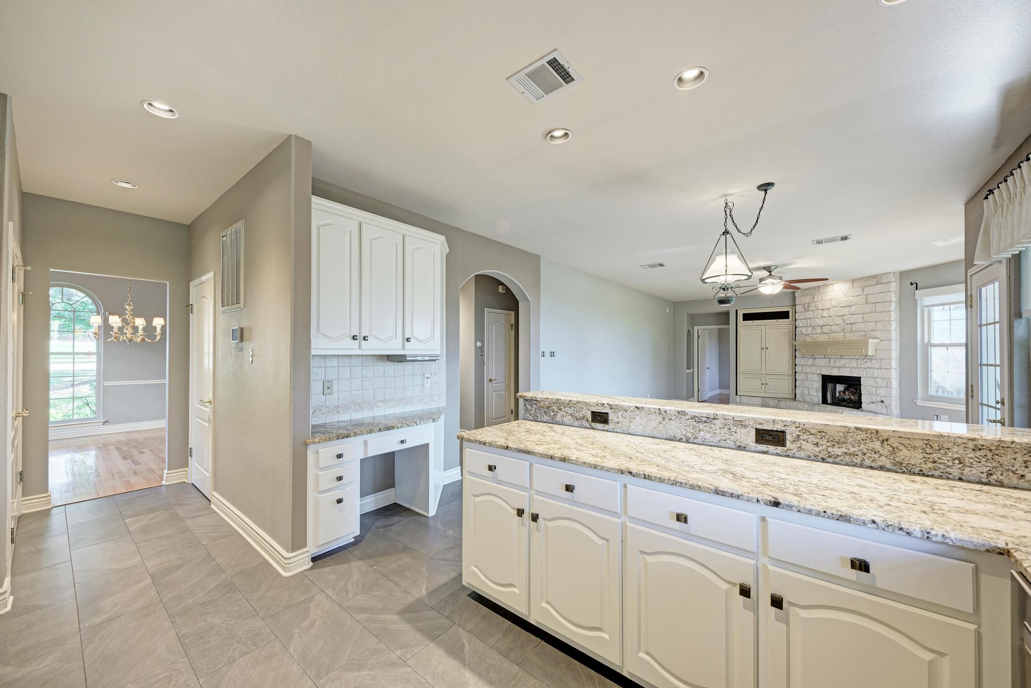 906 Antelope Ridge Cedar Park, TX 78613 - Photo 18 of 40 Granite counters and tiled floors define this spacious kitchen opening to the adjacent living area.