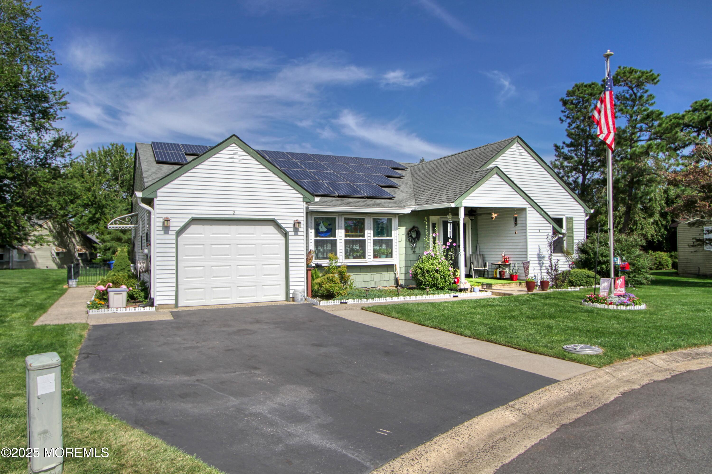 2 Norwood Court Whiting, NJ 08759 - Photo 1 of 22 a front view of a house with a yard and garage