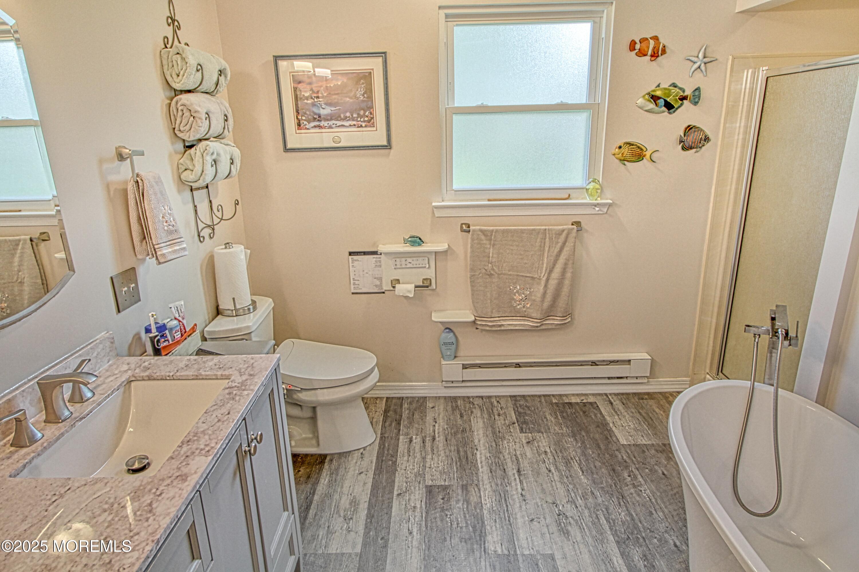 2 Norwood Court Whiting, NJ 08759 - Photo 8 of 22 a bathroom with a granite countertop sink a toilet and a shower curtain