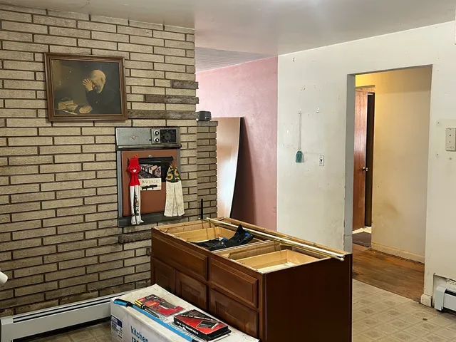 a view of a room with a window and a ceiling fan