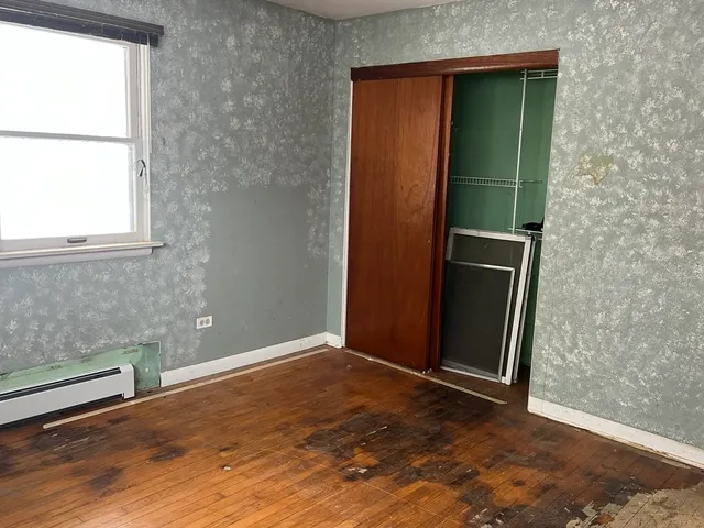 a view of an empty room with a fireplace