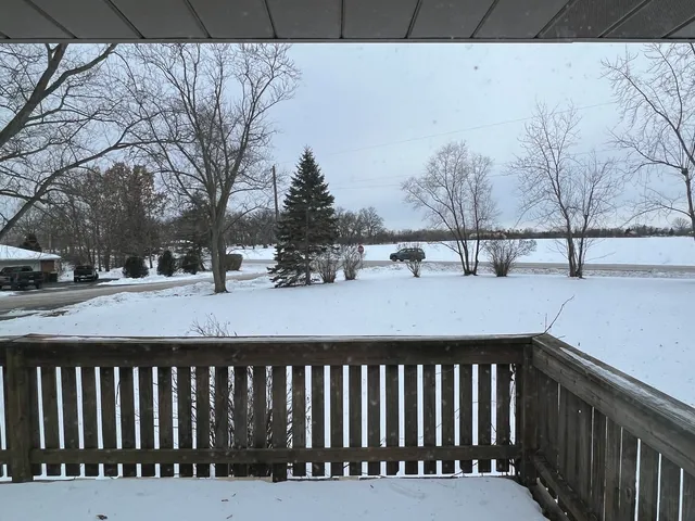 a view of a yard with snow on the road