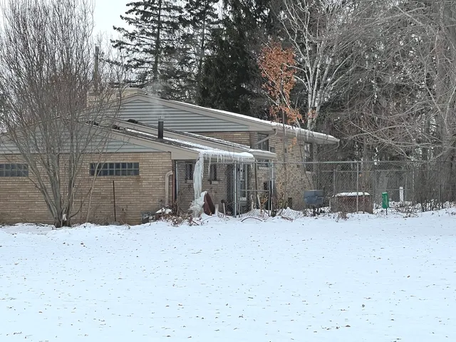 a view of a house covered in snow