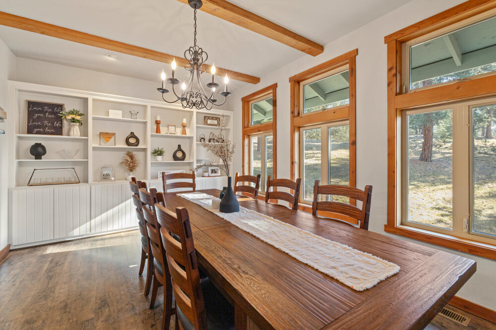 11750 Merganser Road Klamath Falls, OR 97601 - Photo 21 of 66 a view of a dining room with furniture large windows and wooden floor
