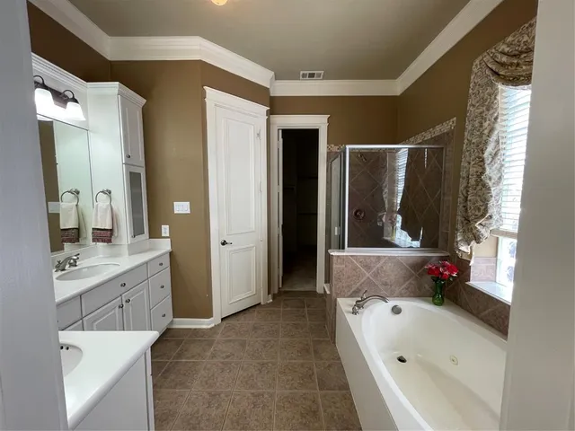 a bathroom with a tub sink and mirror