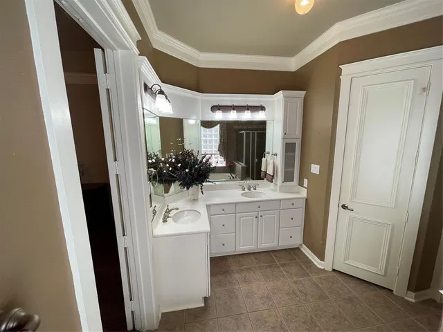a bathroom with a double vanity sink and mirror