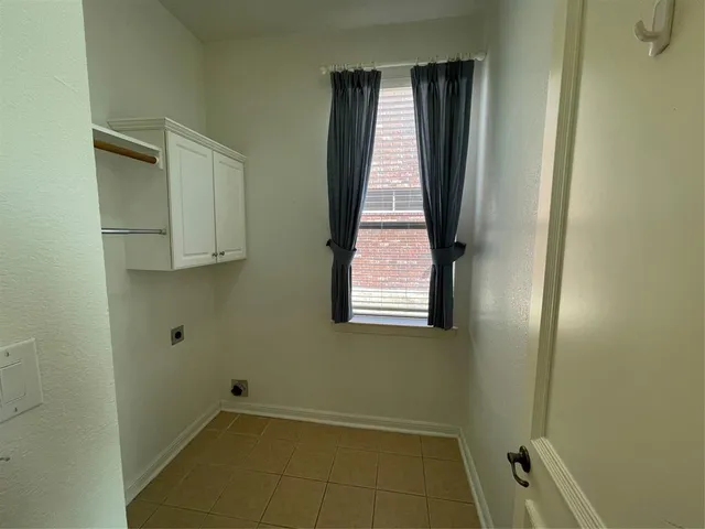 a view of a room with rack on the wall and a window