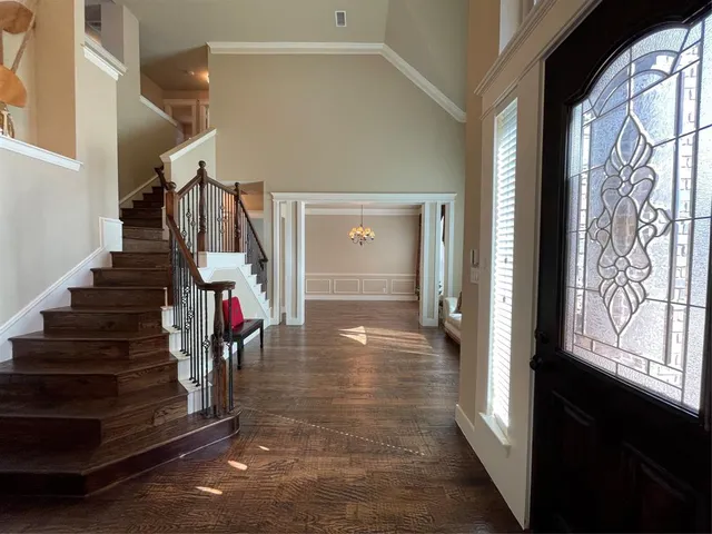a view of entryway and hall with wooden floor