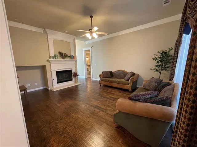 a living room with furniture fireplace and a chandelier