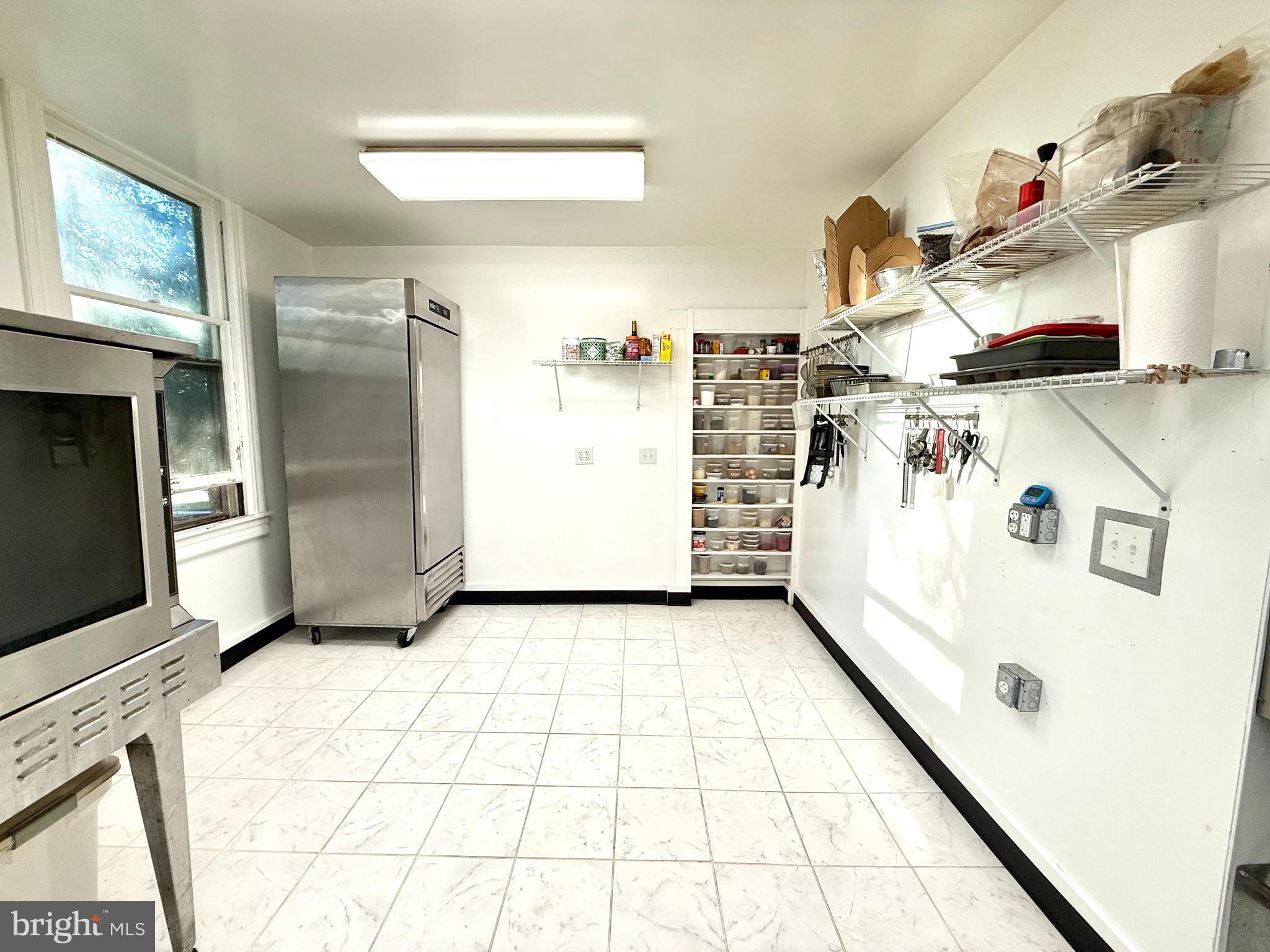 4 South 1st Street Denton, MD 21629 - Photo 60 of 123 a kitchen with a refrigerator a stove a washer and dryer