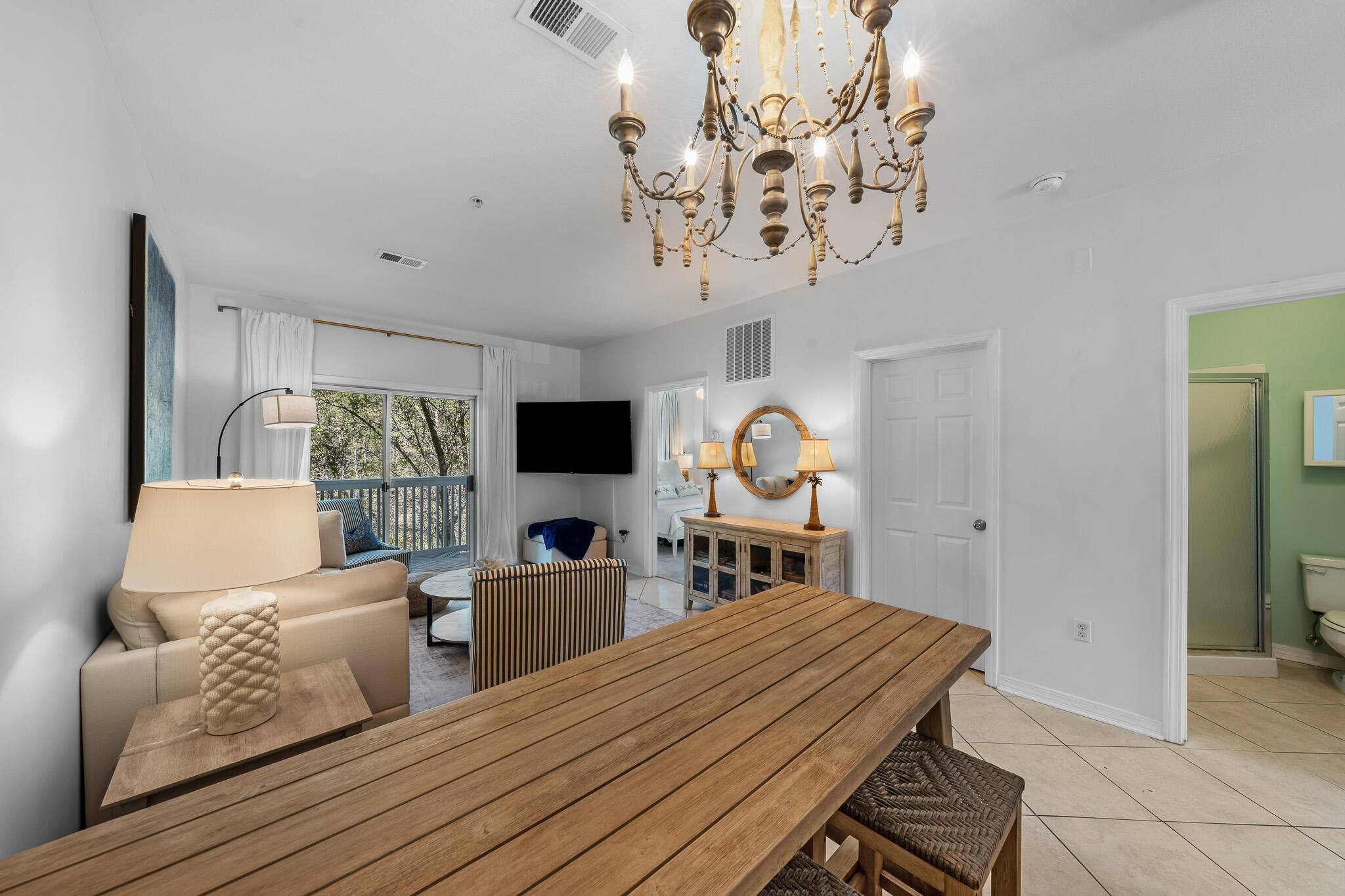 34 Heron's Watch Way, Unit 7205 Santa Rosa Beach, FL 32459 - Photo 12 of 49 a living room with furniture a chandelier and a flat screen tv