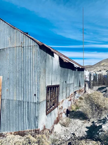 a view of a backyard with wooden fence
