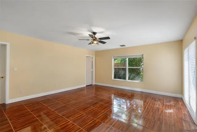 a view of a kitchen with wooden floor and a ceiling fan
