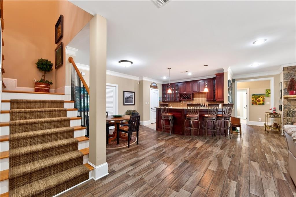 110 Roxbury Row Alpharetta, GA 30004 - Photo 22 of 45 a view of a dining room with furniture window and wooden floor