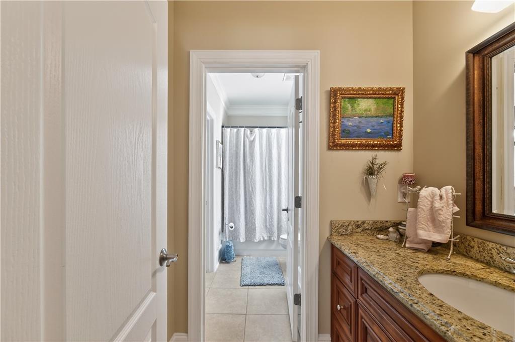 110 Roxbury Row Alpharetta, GA 30004 - Photo 28 of 45 a bathroom with a granite countertop sink a mirror and a shower