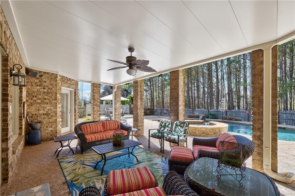110 Roxbury Row Alpharetta, GA 30004 - Photo 32 of 45 a living room with furniture and a floor to ceiling window