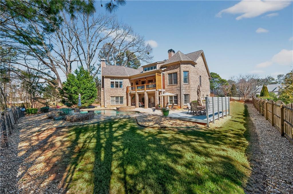 110 Roxbury Row Alpharetta, GA 30004 - Photo 36 of 45 a front view of a house with a yard table and chairs