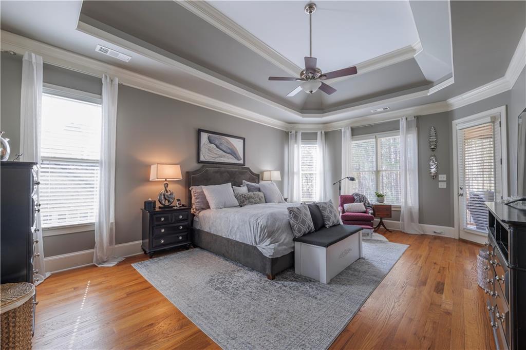 110 Roxbury Row Alpharetta, GA 30004 - Photo 8 of 45 a spacious bedroom with a large bed and a chandelier