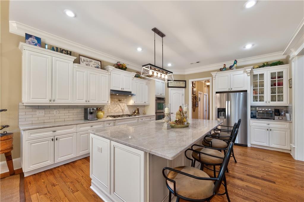 110 Roxbury Row Alpharetta, GA 30004 - Photo 10 of 45 a kitchen with sink cabinets and wooden floor