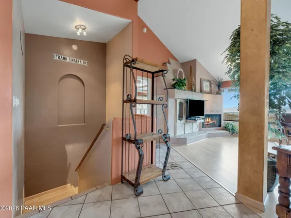 a bathroom with a toilet a sink and a book shelf