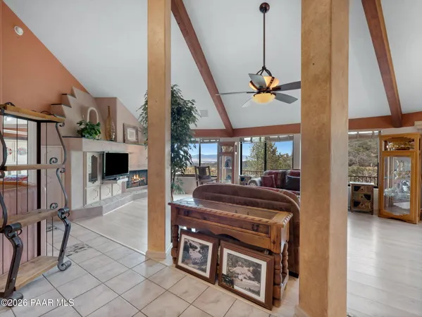 a living room with furniture fireplace and a large window