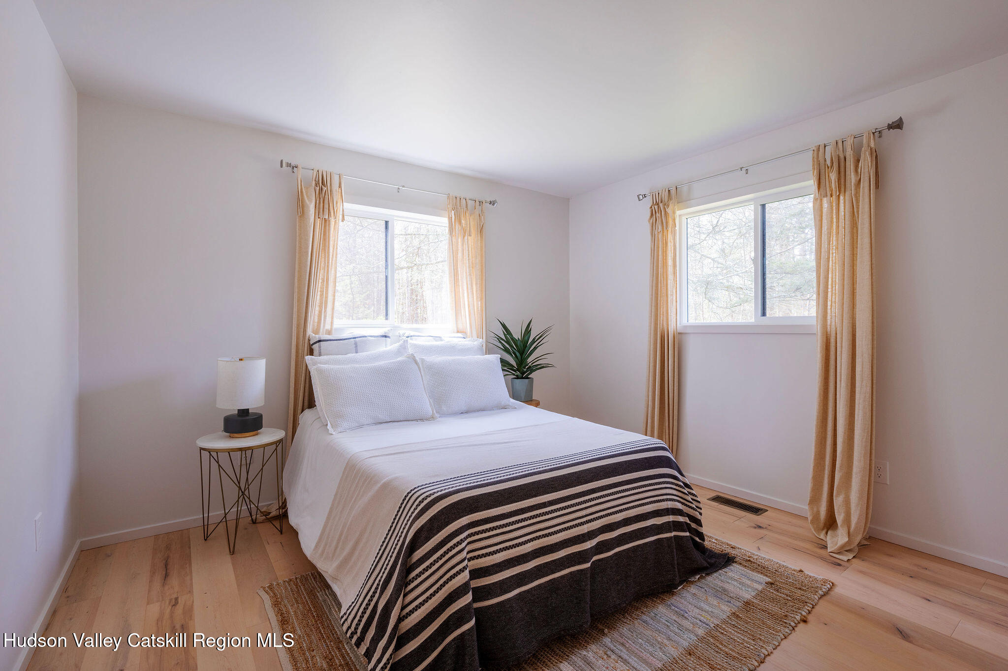 25 Upper Cherrytown Road Kerhonkson, NY 12446 - Photo 11 of 29 a bedroom with a bed and wooden floor