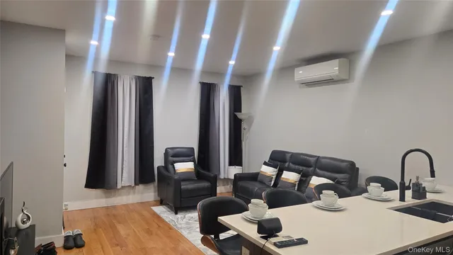 a kitchen with stainless steel appliances a table chairs refrigerator and microwave