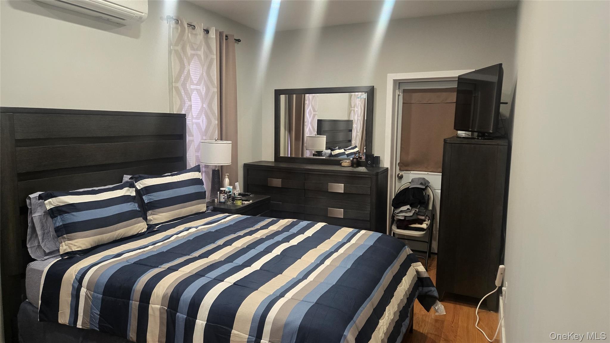 1008 Lenox Road Brooklyn, NY 11212 - Photo 6 of 13 Bedroom featuring a wall mounted AC, wood finished floors, and a closet