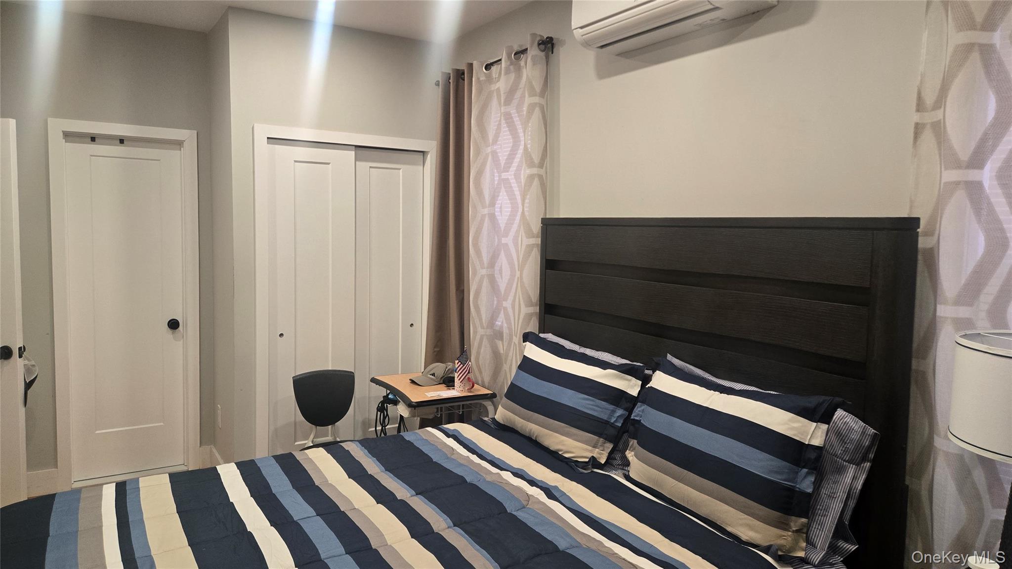 1008 Lenox Road Brooklyn, NY 11212 - Photo 7 of 13 Bedroom featuring a wall mounted AC and a closet