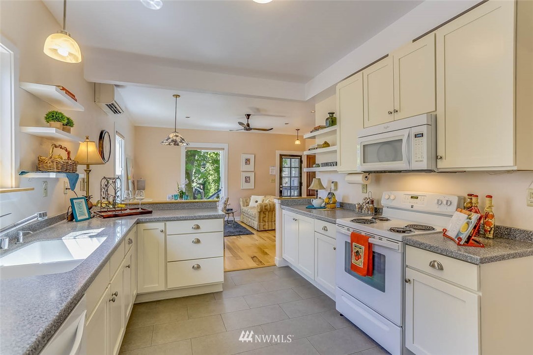 18518 103rd Avenue Northeast Bothell, WA 98011 - Photo 11 of 31 a kitchen with white cabinets and appliances