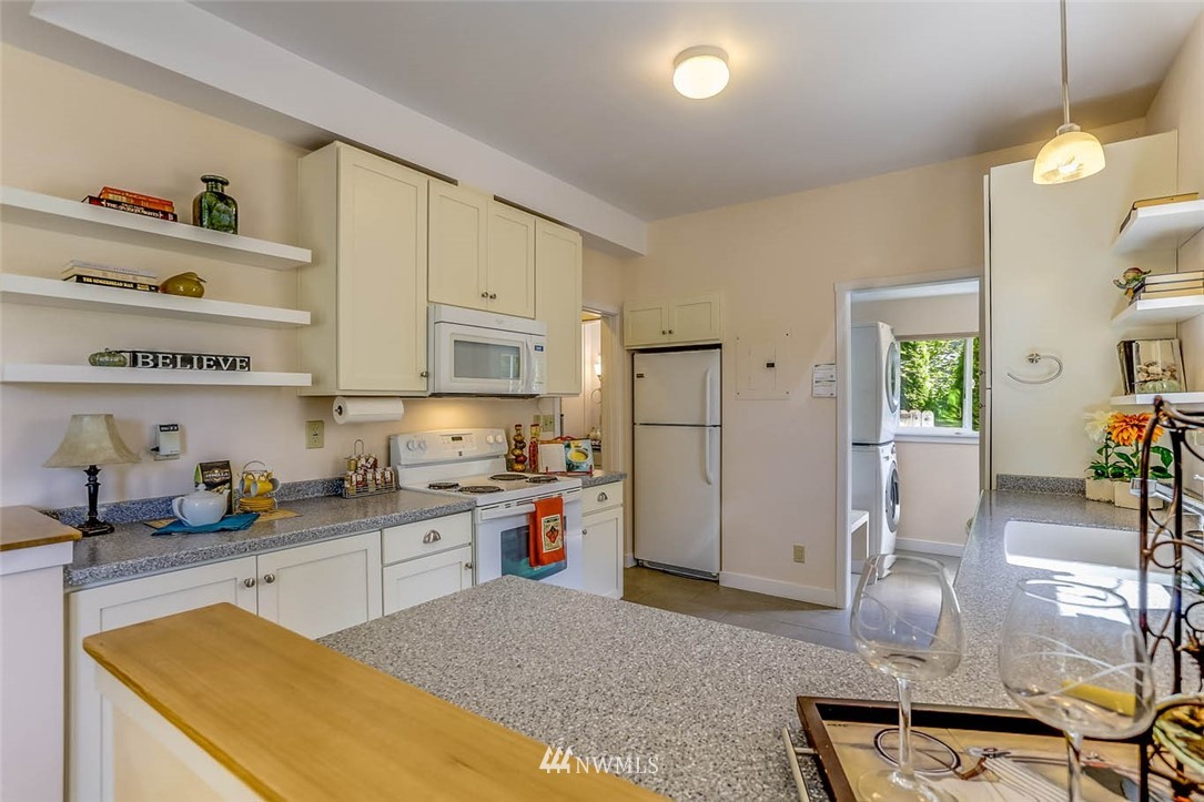 18518 103rd Avenue Northeast Bothell, WA 98011 - Photo 12 of 31 a kitchen that has a lot of cabinets a sink and appliances in it