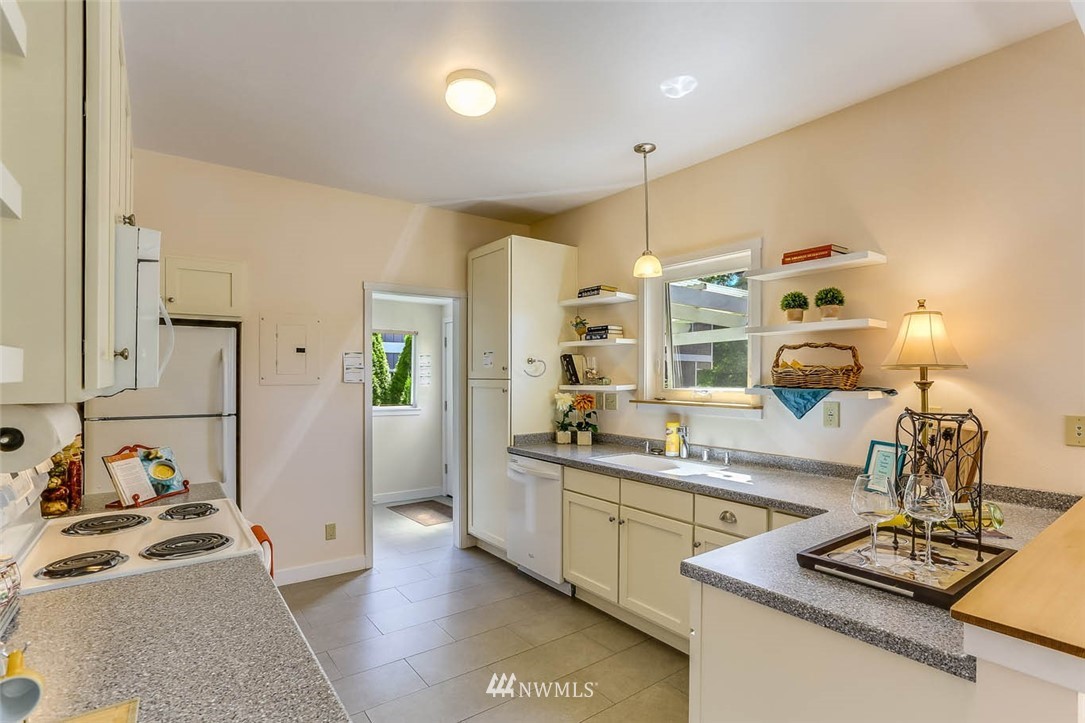 18518 103rd Avenue Northeast Bothell, WA 98011 - Photo 13 of 31 a living room with kitchen island furniture and a wooden floor