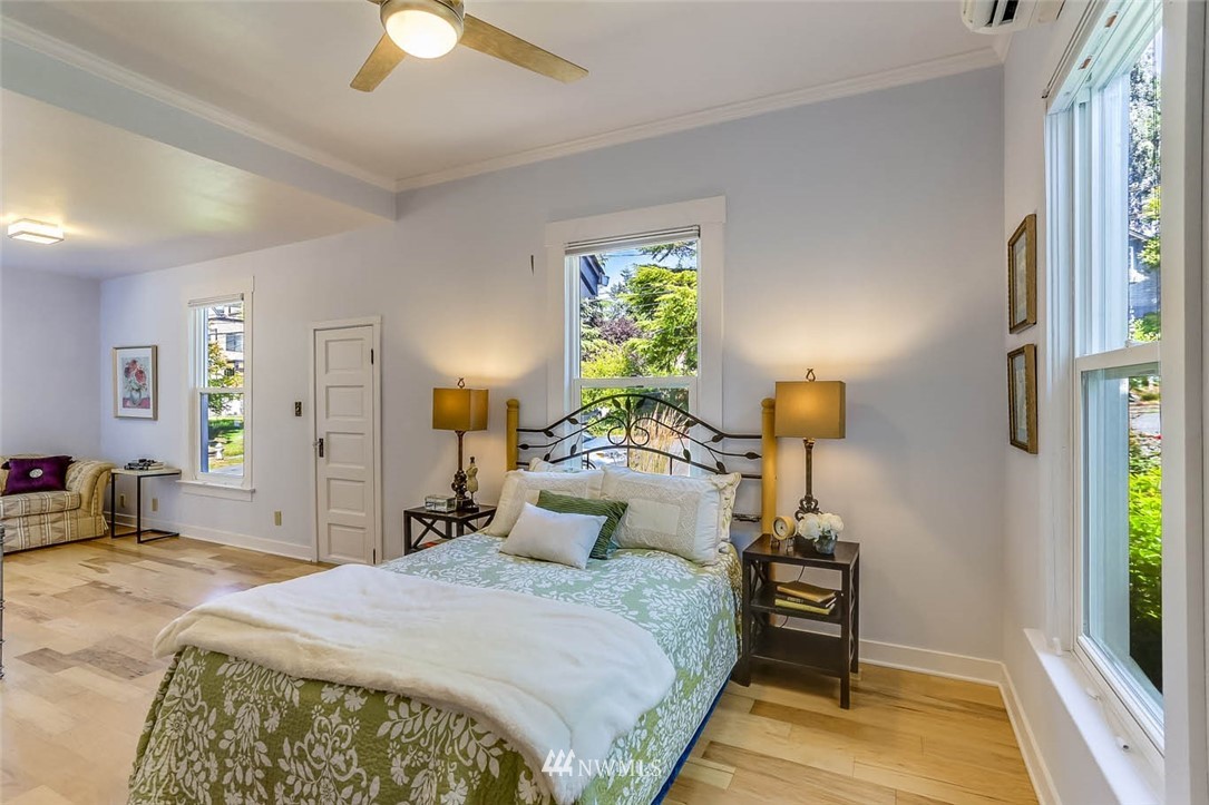 18518 103rd Avenue Northeast Bothell, WA 98011 - Photo 15 of 31 a bedroom with a bed and a chandelier