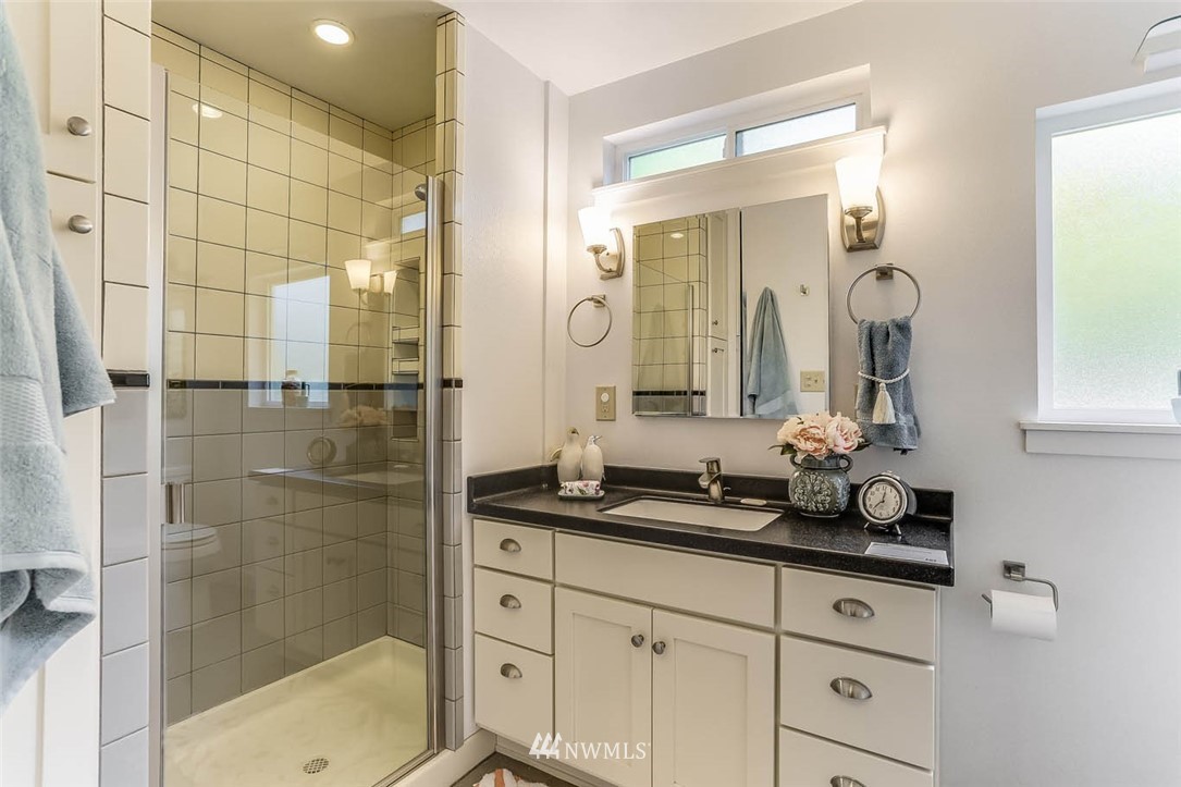 18518 103rd Avenue Northeast Bothell, WA 98011 - Photo 18 of 31 a bathroom with a double vanity sink mirror and shower
