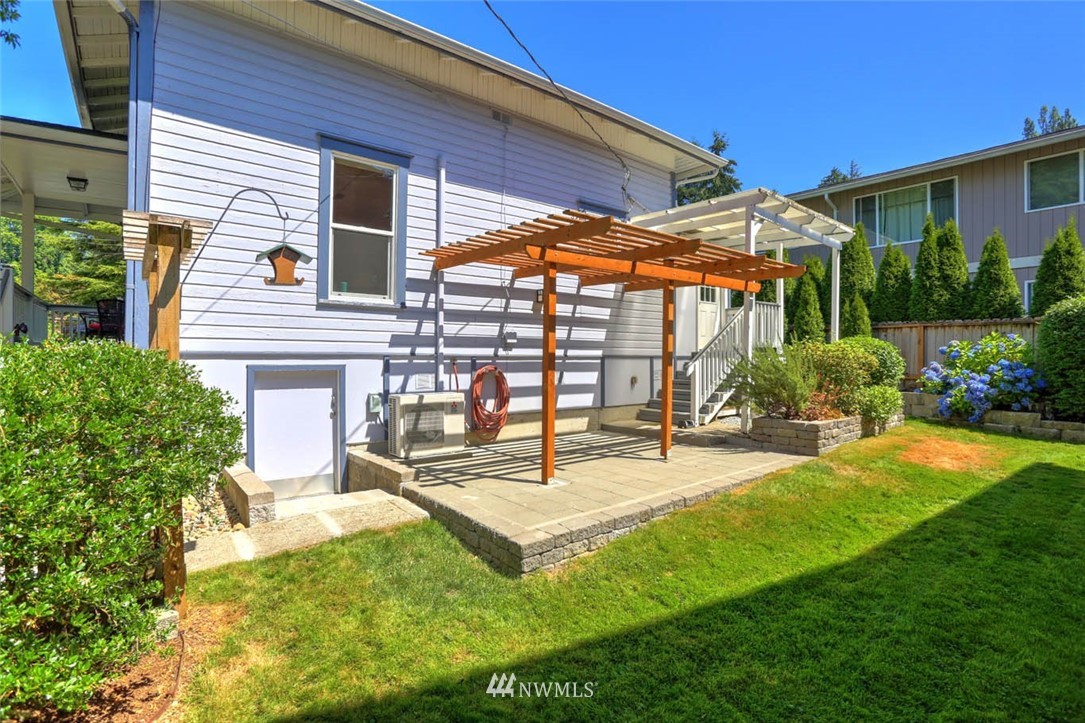 18518 103rd Avenue Northeast Bothell, WA 98011 - Photo 24 of 31 a patio with a table and chairs and potted plants
