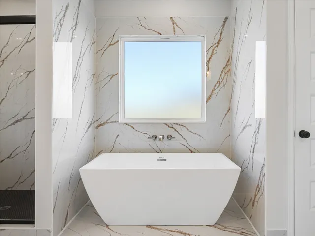 a white bath tub sitting in a bathroom