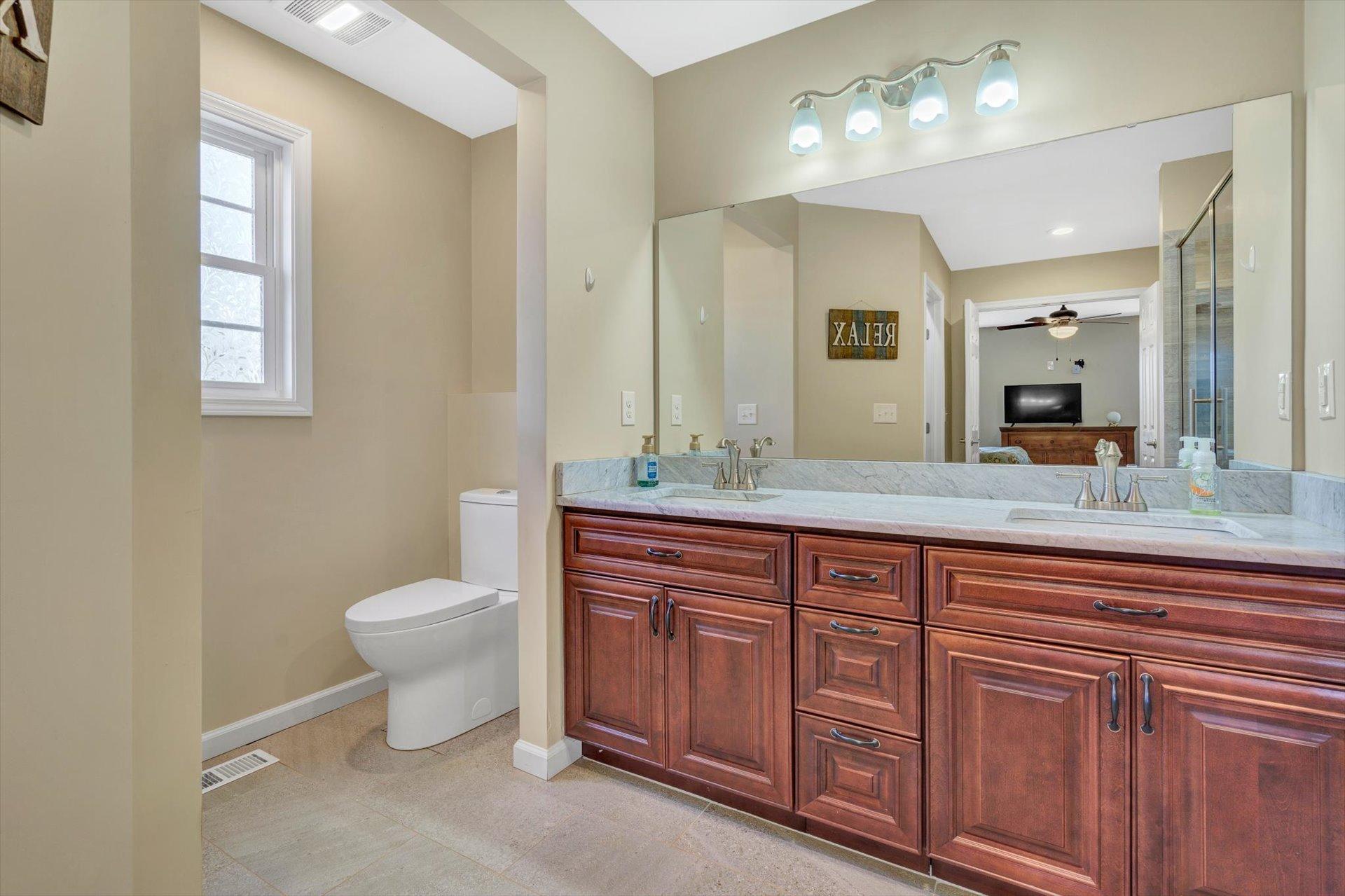 3294 Ayers Road Moneta, VA 24121 - Photo 16 of 41 a spacious bathroom with a double vanity sink a toilet and a mirror