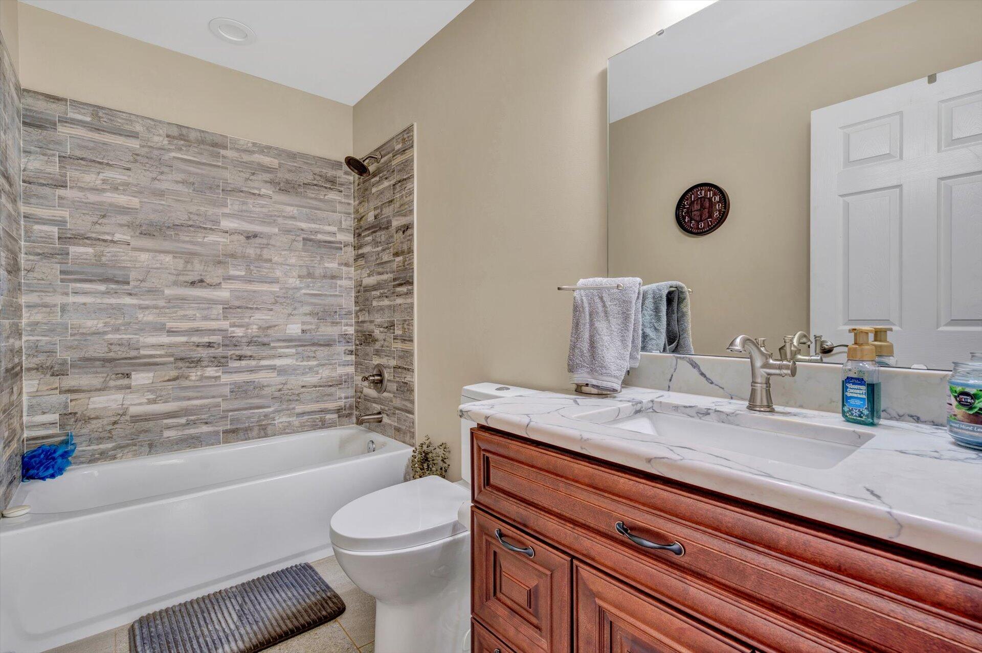 3294 Ayers Road Moneta, VA 24121 - Photo 20 of 41 a bathroom with a granite countertop bathtub sink vanity mirror and toilet