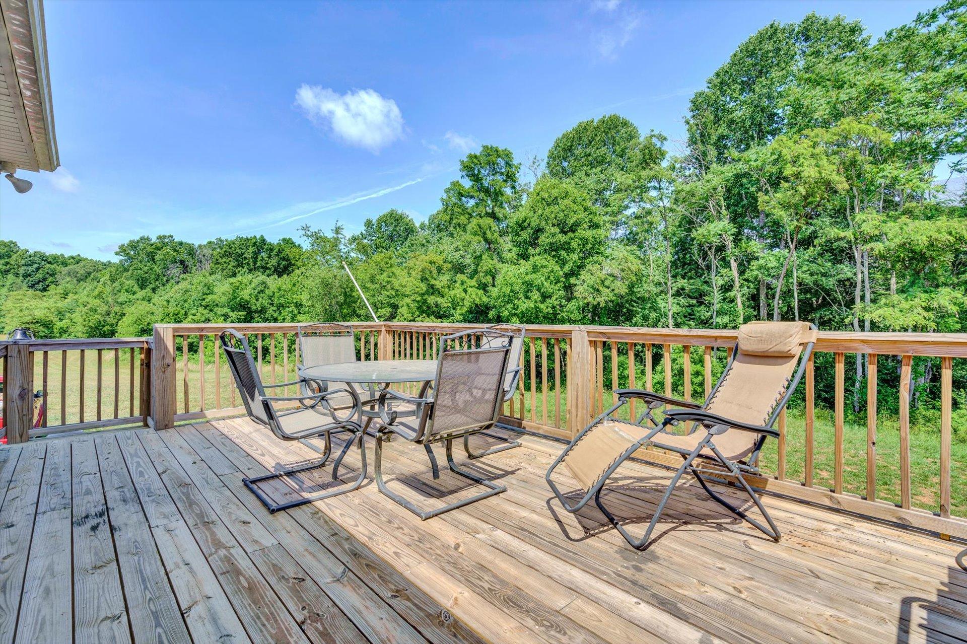 3294 Ayers Road Moneta, VA 24121 - Photo 21 of 41 a roof deck with table and chairs and wooden floor
